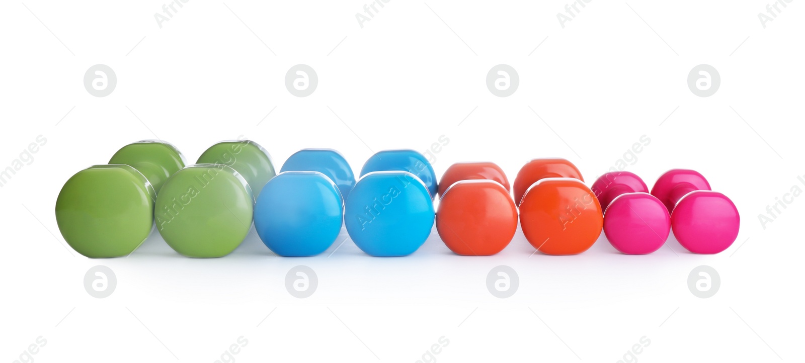 Photo of Many colorful dumbbells on white background. Fitness equipment