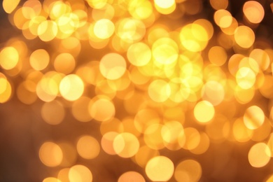 Photo of Gold glitter with bokeh effect on dark background