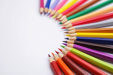 Photo of Colorful wooden pencils on white background, closeup. Space for text