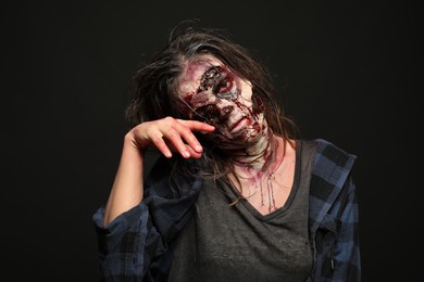 Photo of Scary zombie on dark background. Halloween monster