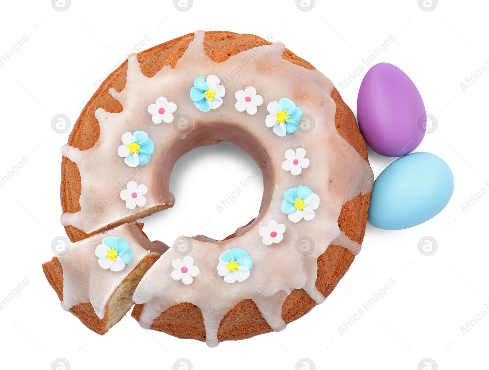 Photo of Festively decorated Easter cake and painted eggs on white background, top view