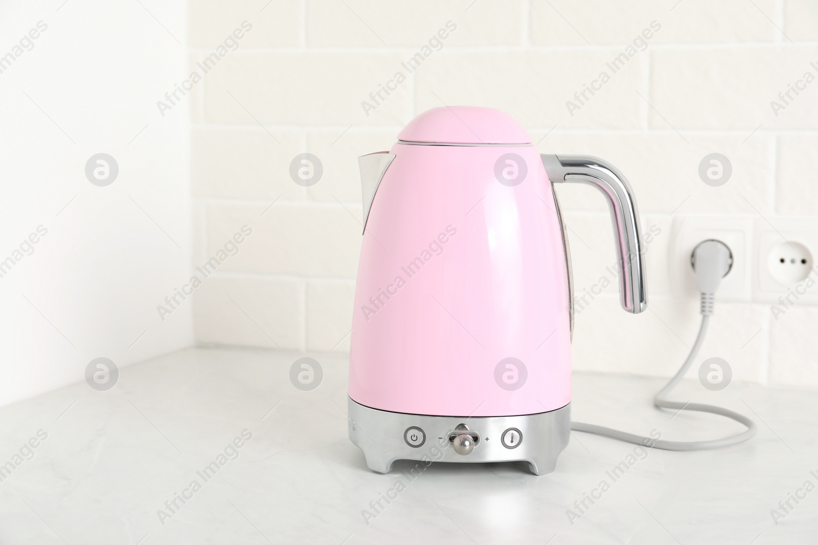 Photo of Modern electric kettle on counter in kitchen