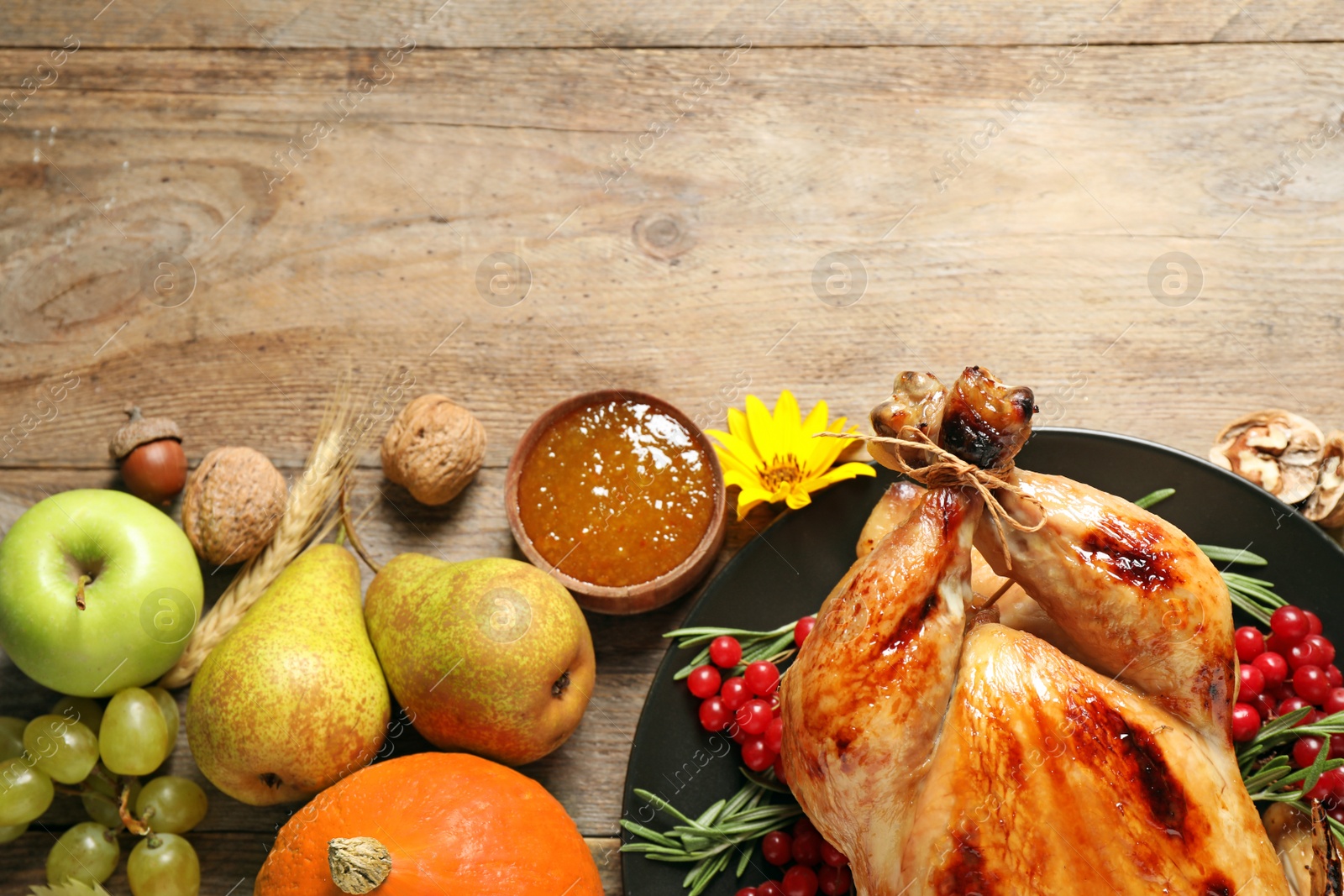 Photo of Flat lay composition with turkey on wooden background, space for text. Happy Thanksgiving day