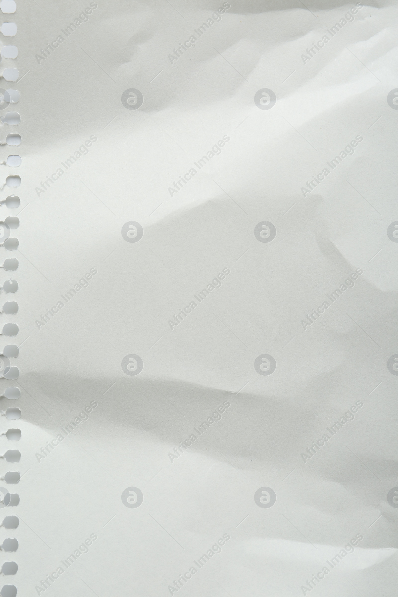 Photo of Blank crumpled notebook sheet as background, top view