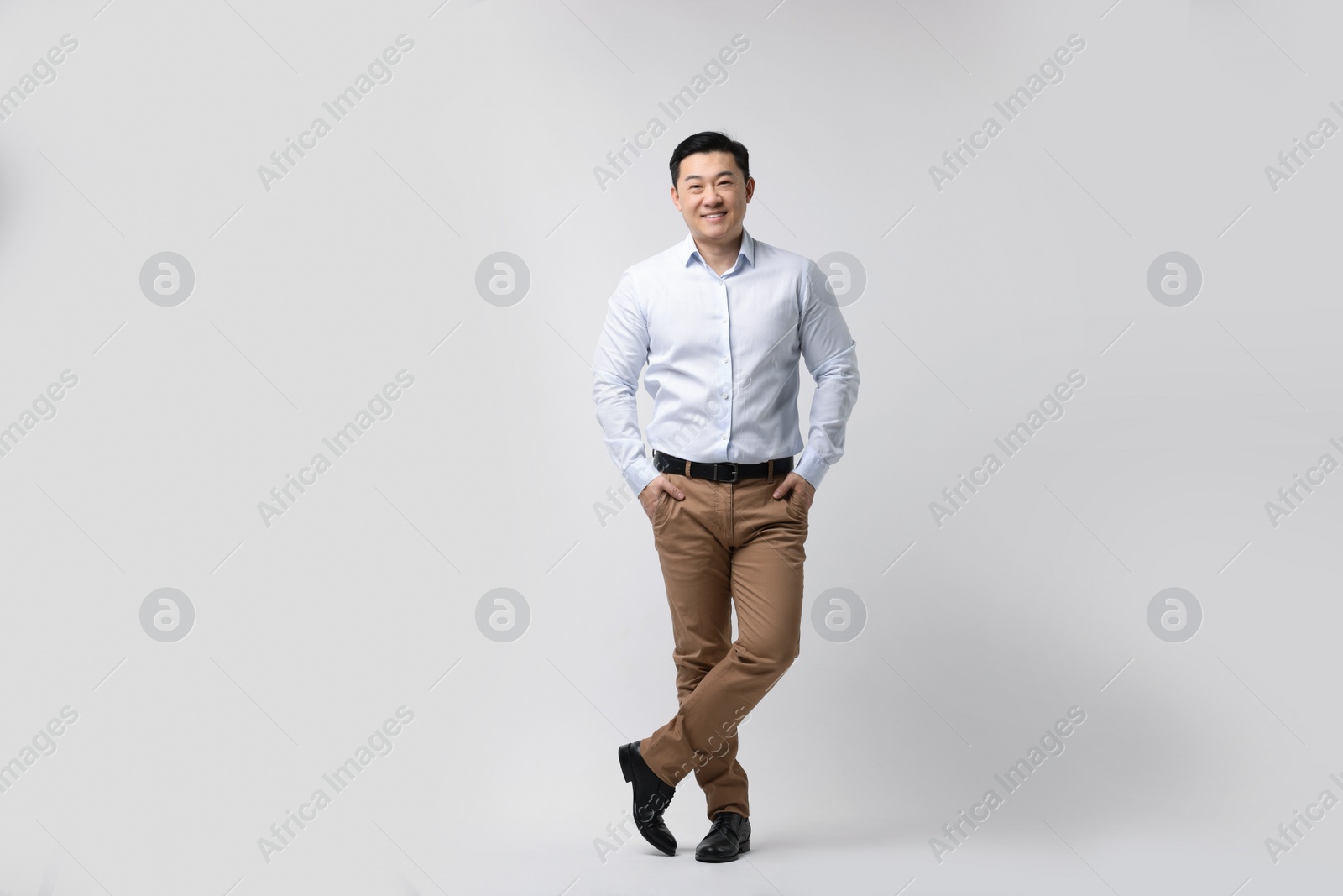 Photo of Full length portrait of happy man on light background