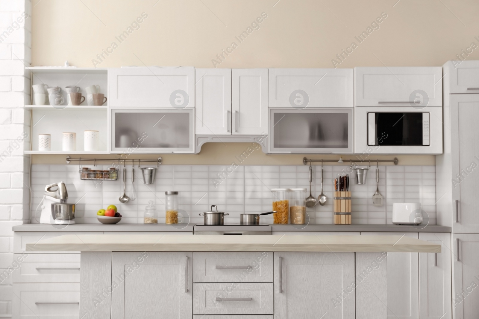 Photo of Modern kitchen interior with houseware and new furniture