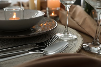 Festive table setting with beautiful tableware and candle, closeup