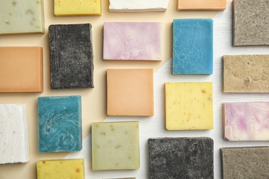 Photo of Hand made soap bars on color background, top view