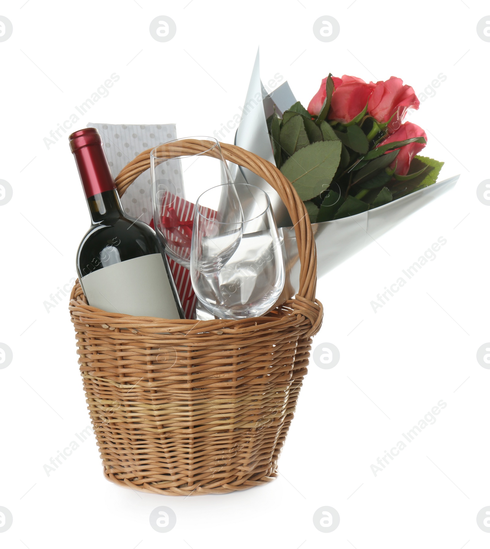 Photo of Wicker basket full of presents isolated on white