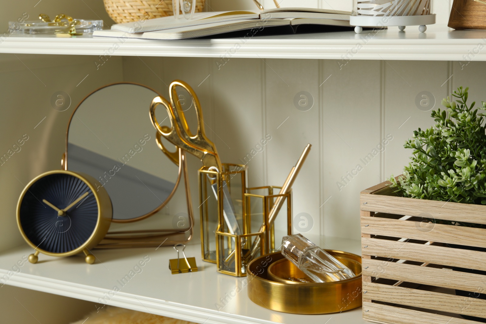 Photo of White shelving unit with different decorative elements