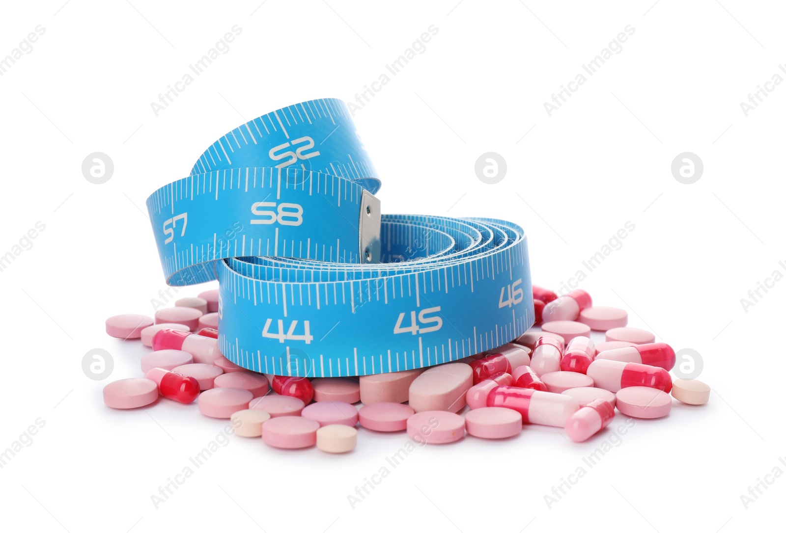 Photo of Weight loss pills and measuring tape on white background