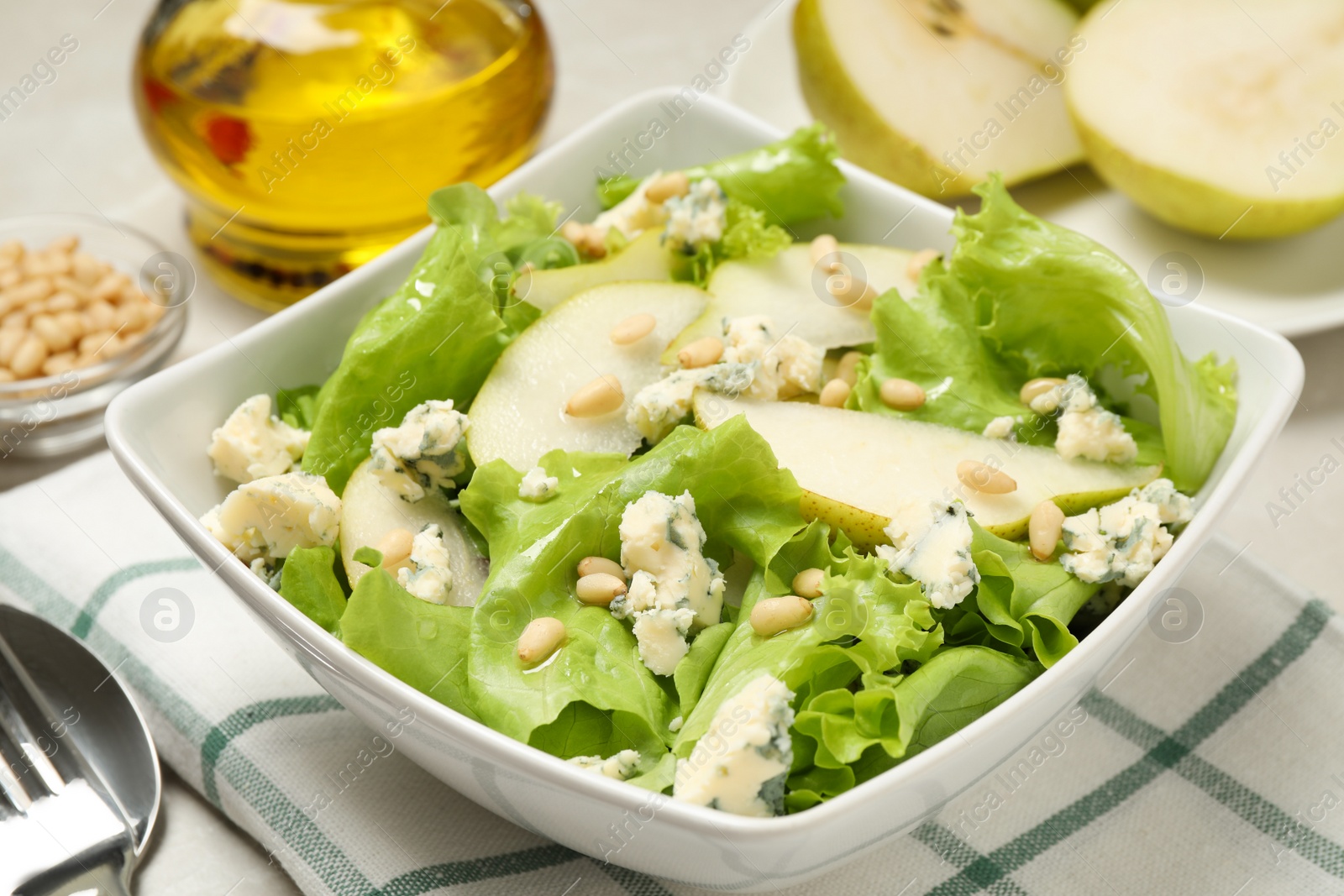 Photo of Fresh salad with pear served on table, closeup