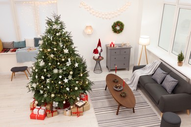Beautiful Christmas tree and stylish furniture in cozy room, above view. Interior design