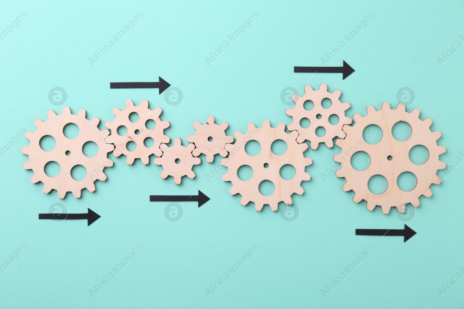 Photo of Business process organization and optimization. Scheme with wooden figures and arrows on light blue background, top view