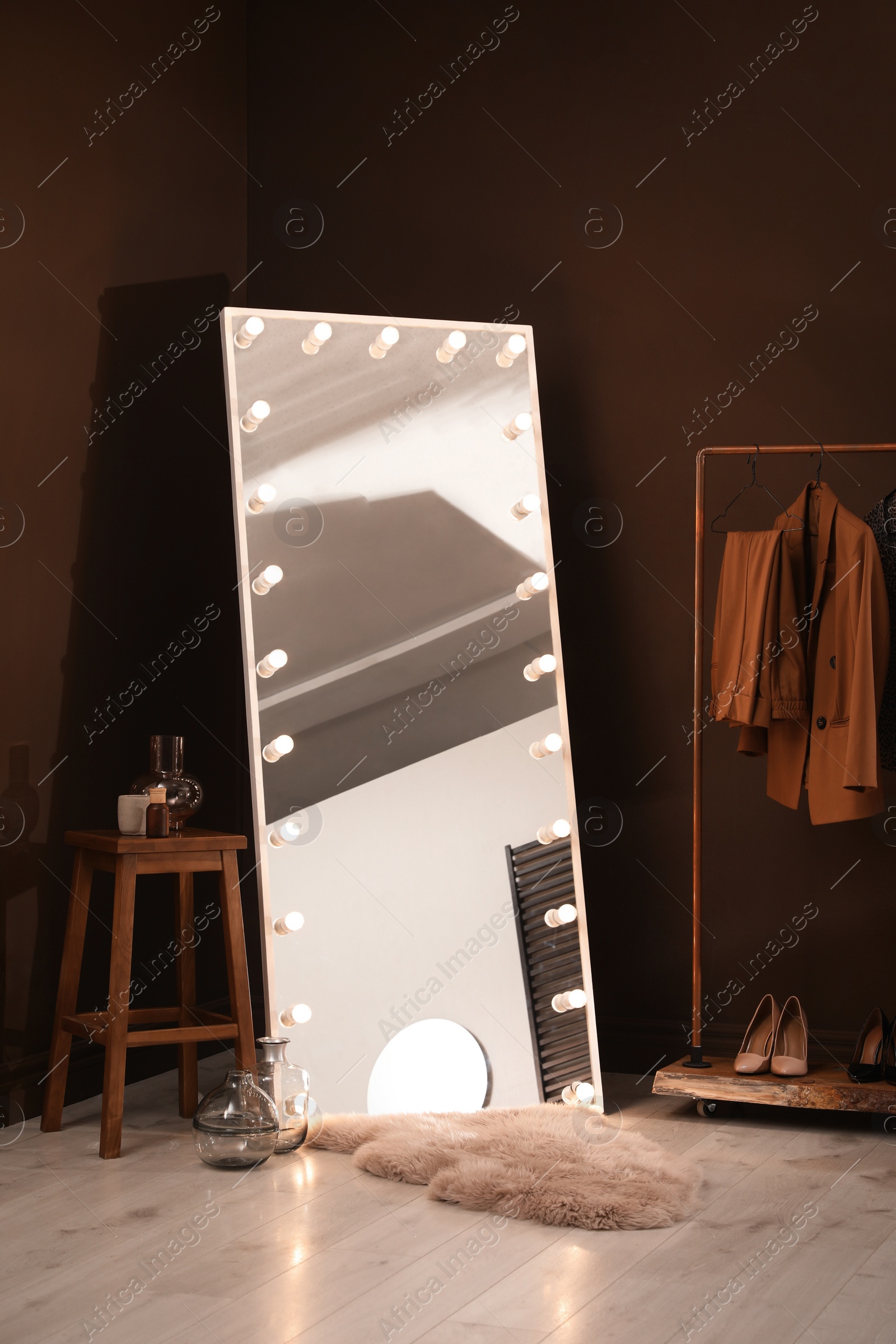 Photo of Stylish mirror with light bulbs in dressing room. Interior design