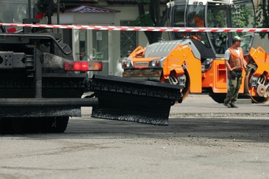Photo of MYKOLAIV, UKRAINE - AUGUST 04, 2021: Road repair machinery on city street