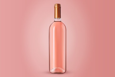 Image of Bottle of expensive rose wine on pink background