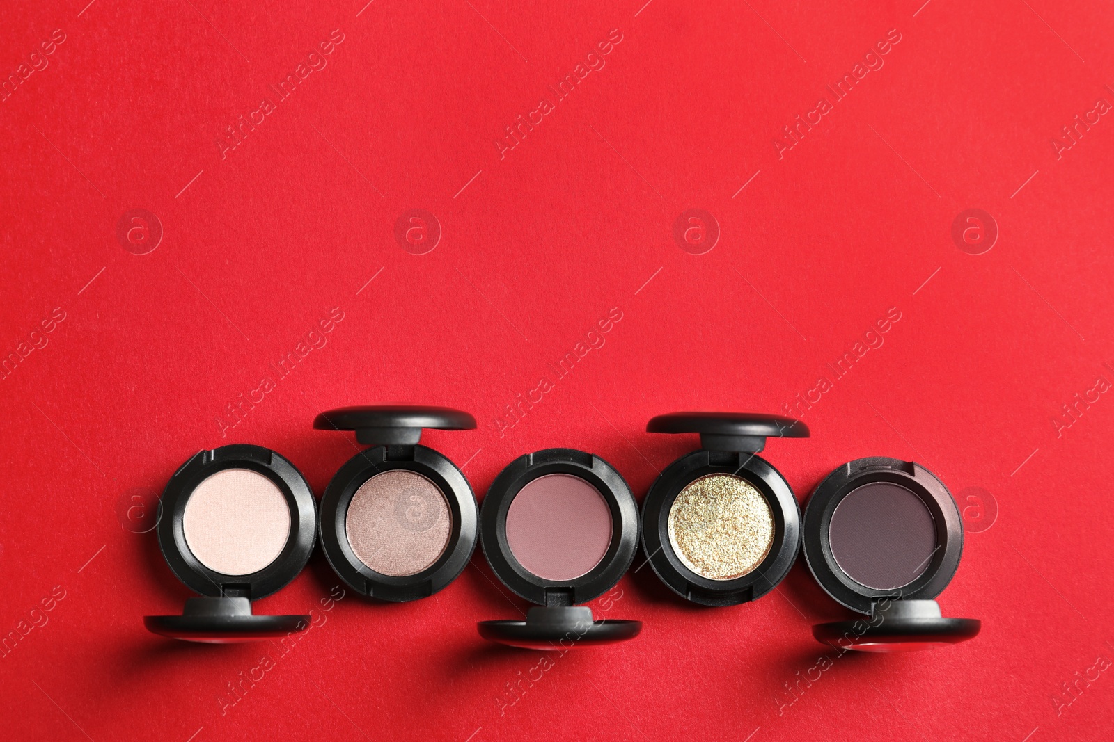 Photo of Flat lay composition with different eye shadows on color background. Space for text