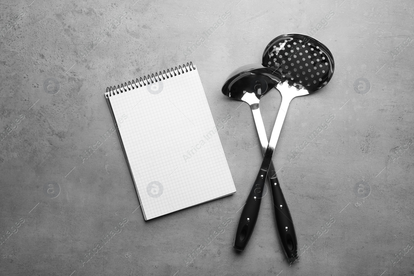 Photo of Kitchen utensils and notebook on grey background, top view with space for text