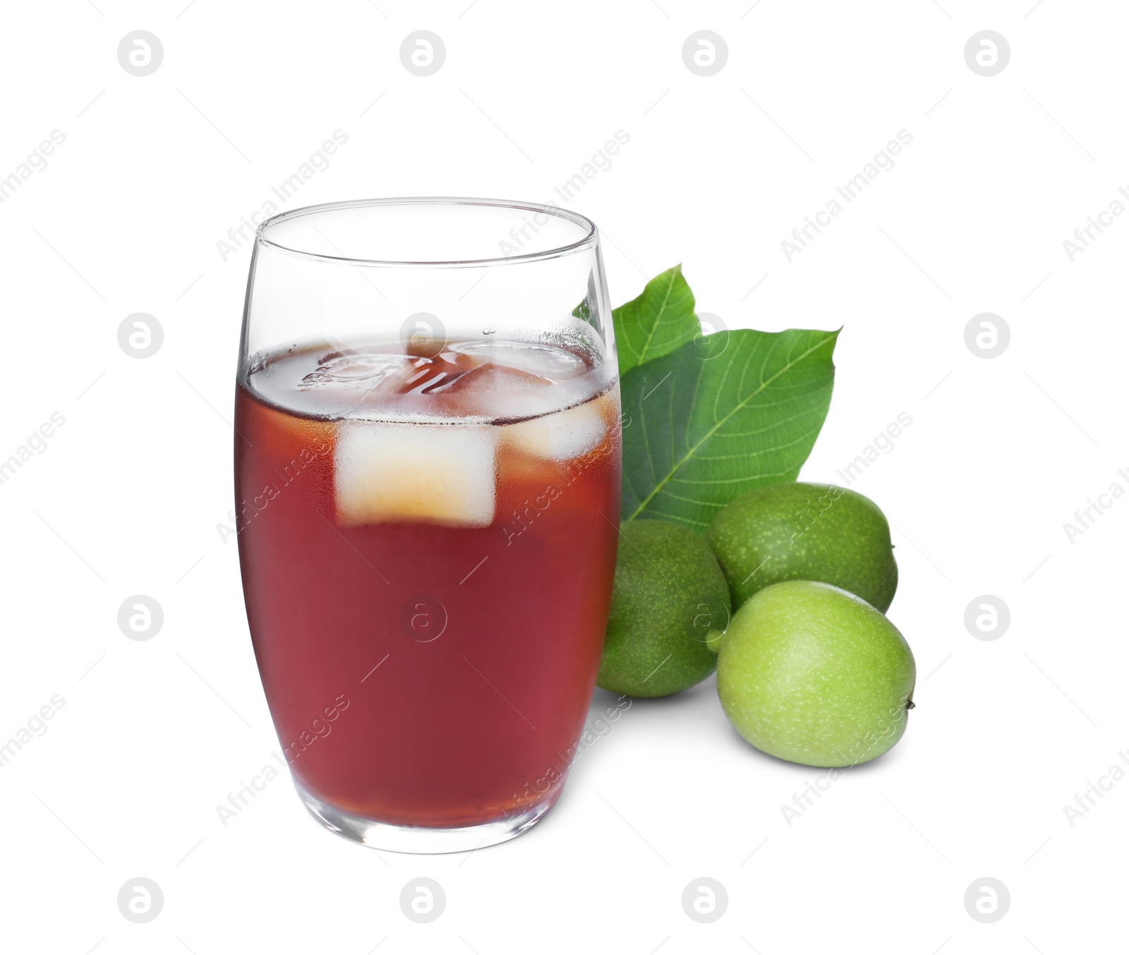 Photo of Delicious liqueur with ice and green walnuts on white background