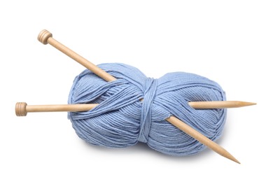 Photo of Soft light blue woolen yarn with knitting needles on white background