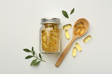 Photo of Bottle, vitamin capsules, spoon and leaves on white background, flat lay