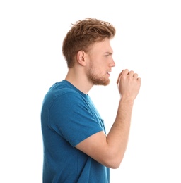 Handsome young man coughing against white background