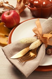 Photo of Festive table setting with autumn decor on wooden background, closeup