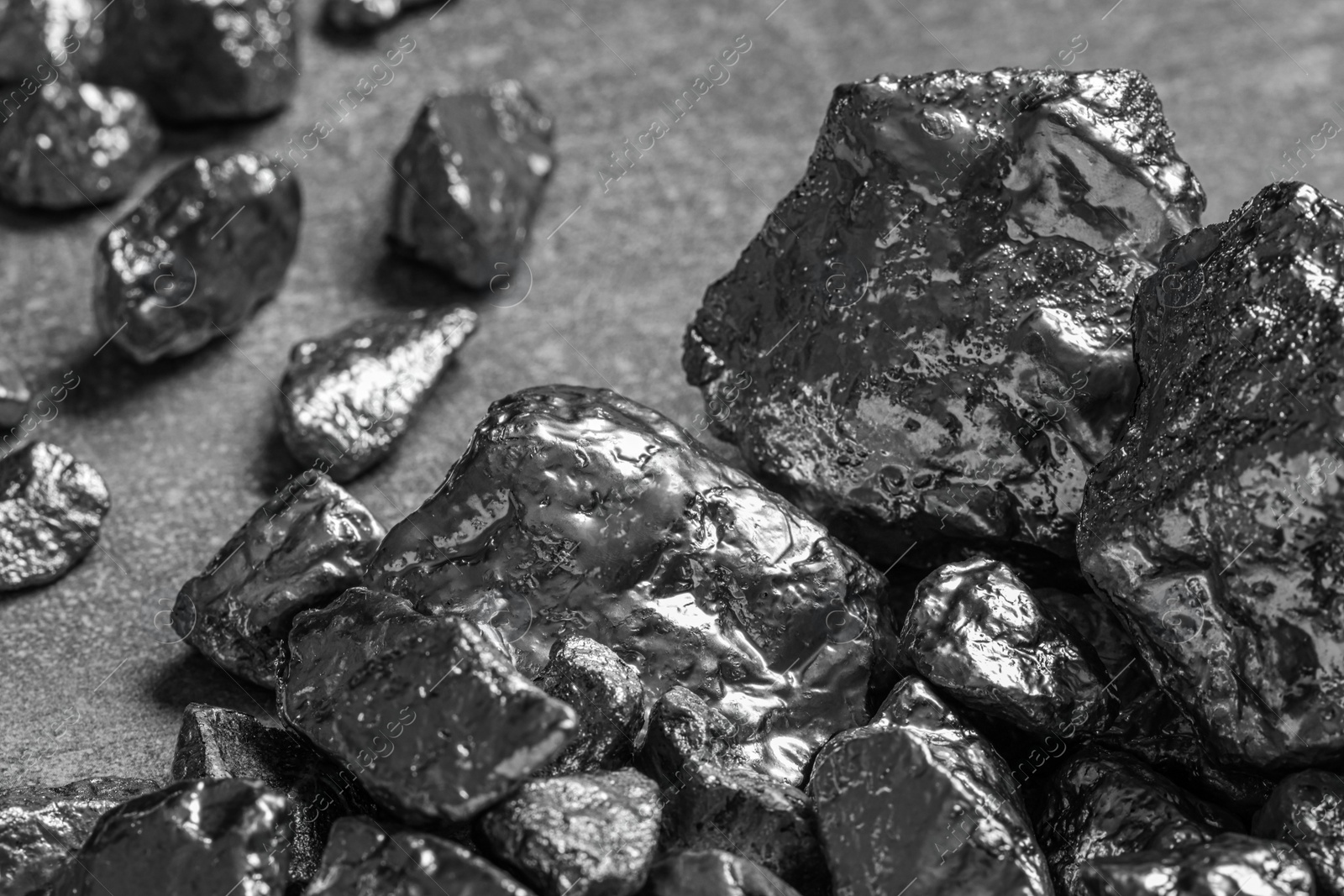 Photo of Pile of silver nuggets on light grey table, closeup