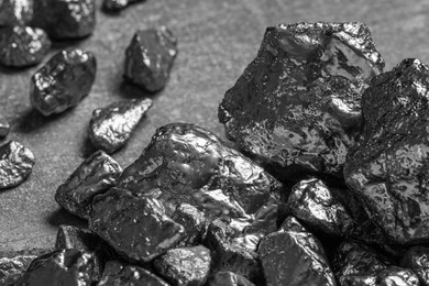 Pile of silver nuggets on light grey table, closeup