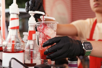 Photo of Male bartender preparing refreshing drink, closeup view