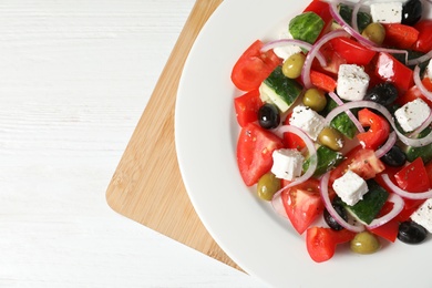 Photo of Plate with delicious salad on table, closeup