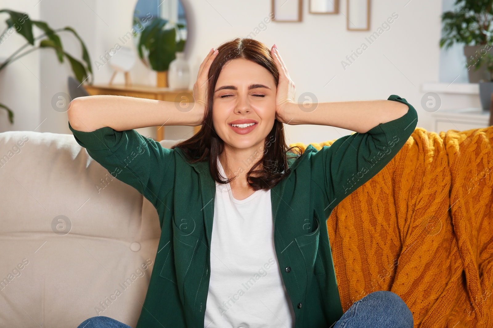 Photo of Young woman suffering from headache indoors. Hormonal disorders