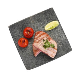 Photo of Pieces of delicious tuna with microgreens, lime and tomatoes on white background, top view