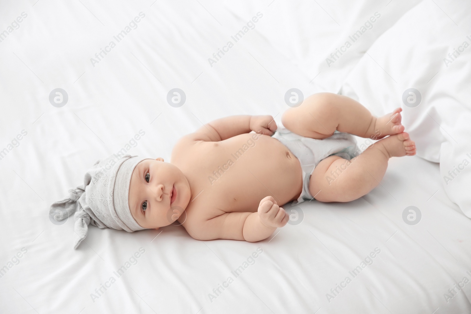 Photo of Adorable baby girl lying on bed