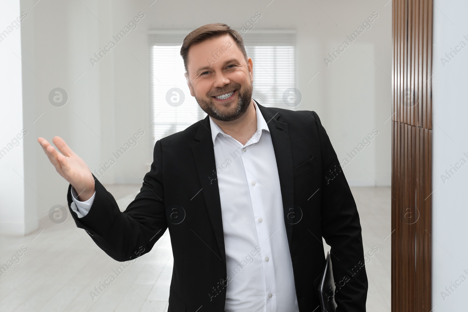 Photo of Male real estate agent showing new apartment