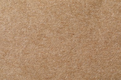 Photo of Texture of kraft paper sheet as background, closeup