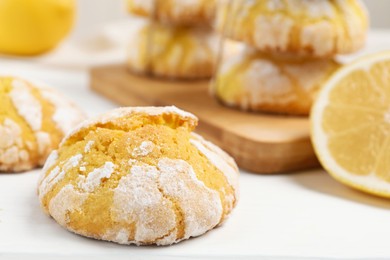 Photo of Tasty homemade lemon cookies on white wooden table, closeup. Space for text