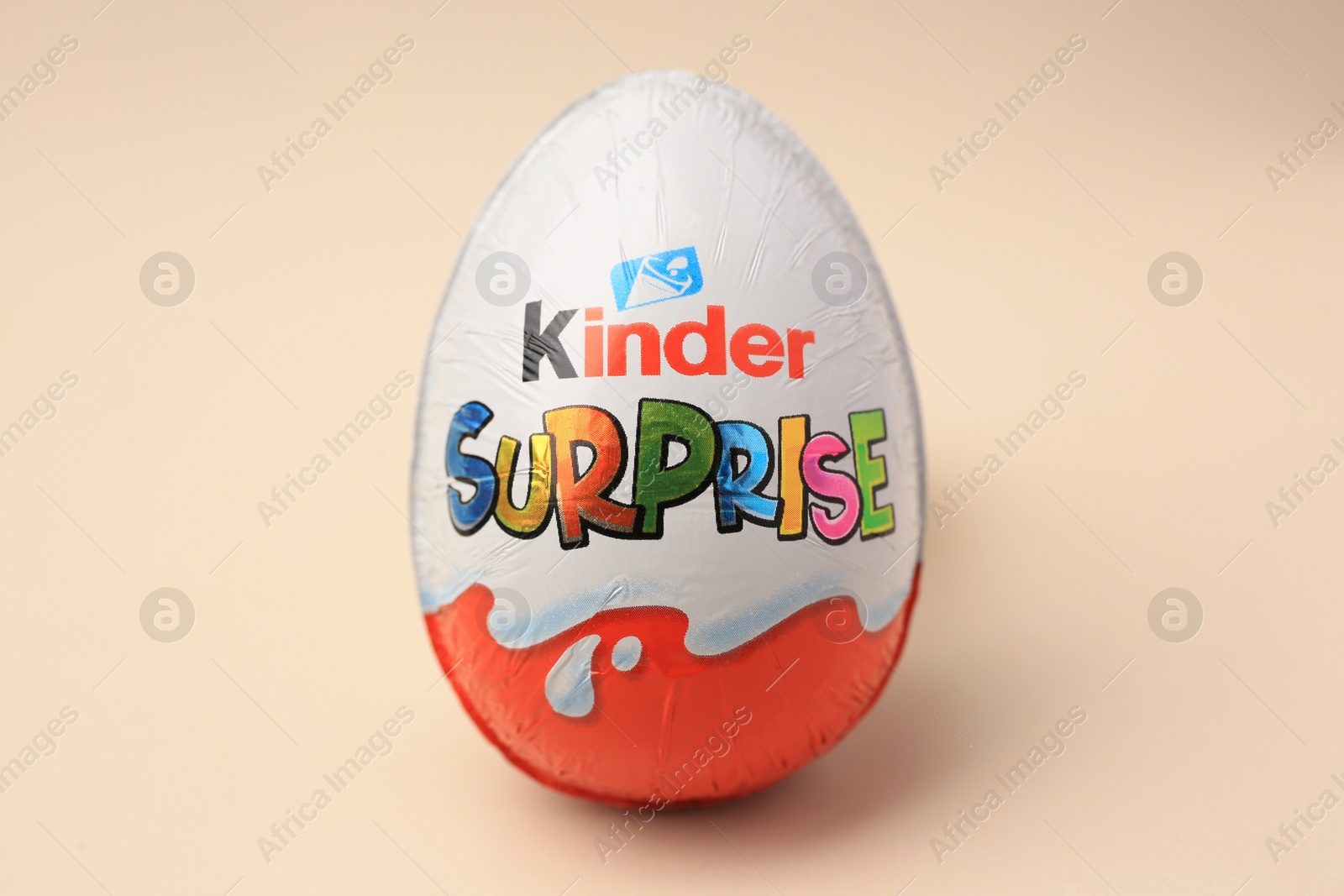 Photo of Slynchev Bryag, Bulgaria - May 25, 2023: Kinder Surprise Egg on beige background