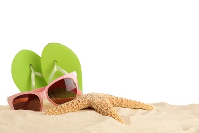 Photo of Beach accessories on sand against white background. Space for text