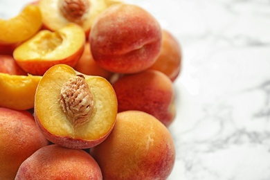 Pile of delicious ripe peaches on table, closeup