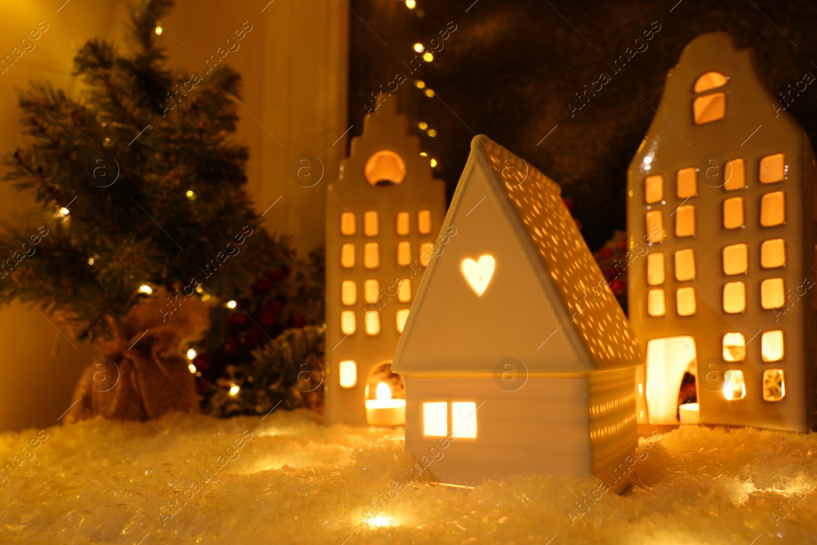 Photo of House shaped lanterns and Christmas decor on windowsill indoors, space for text