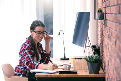 Professional journalist working with computer in office