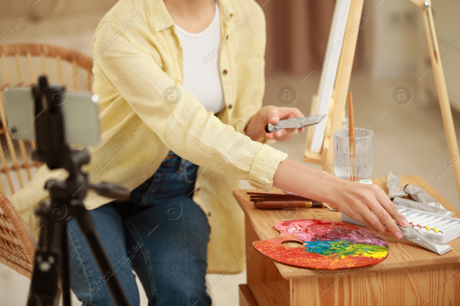 Photo of Teacher conducting online painting lesson at home, closeup. Time for hobby