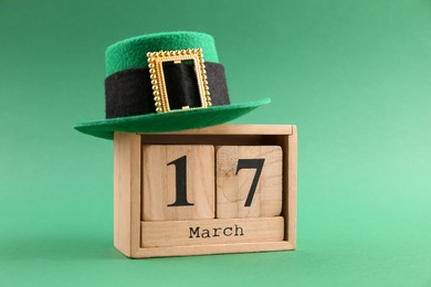 St. Patrick's day - 17th of March. Block calendar and leprechaun hat on green background