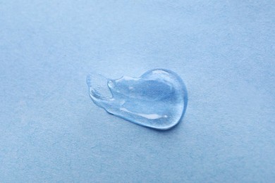 Sample of transparent gel on light blue background, closeup