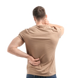 Young man suffering from back pain on white background