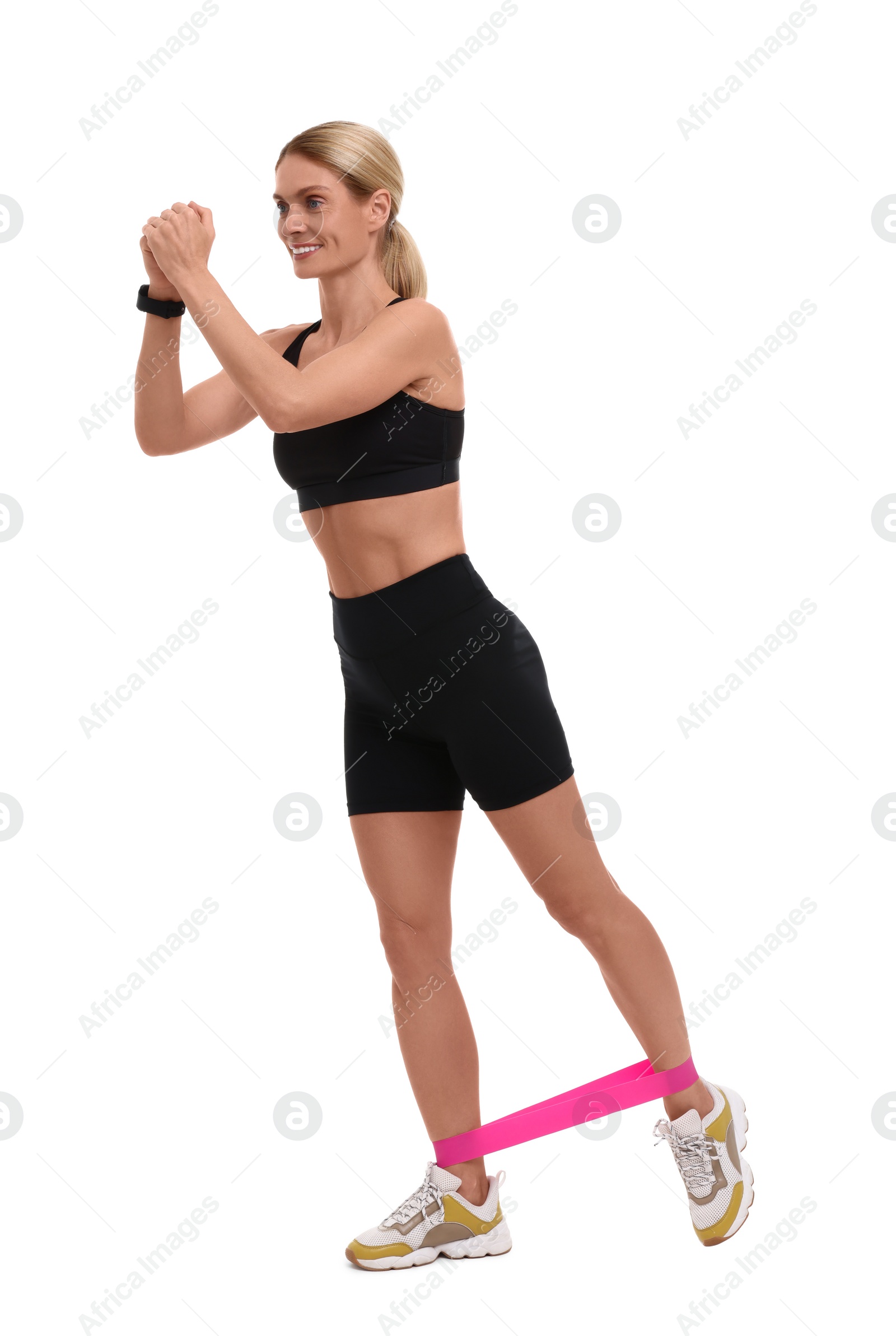 Photo of Woman exercising with elastic resistance band on white background