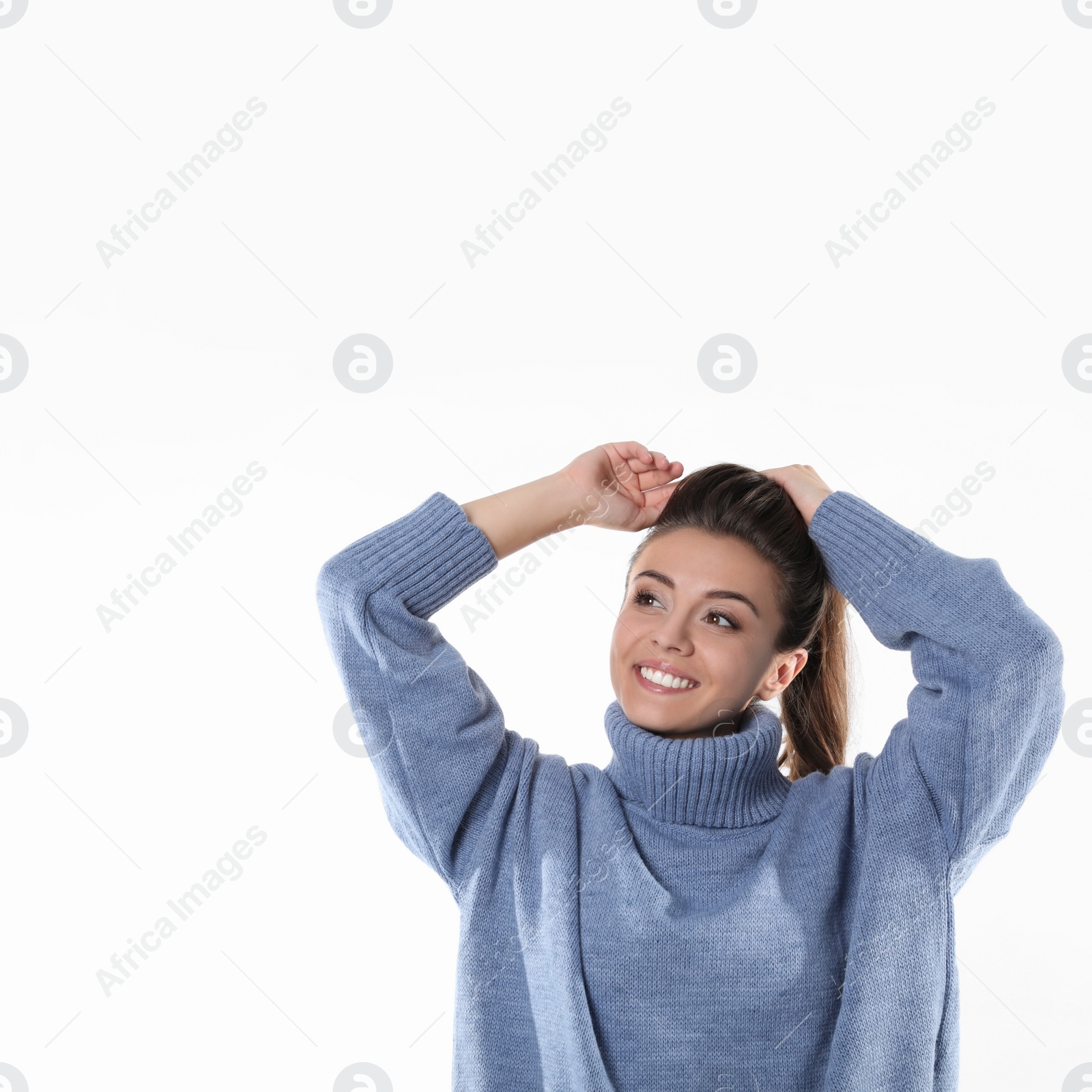 Photo of Young woman in stylish blue sweater on white background