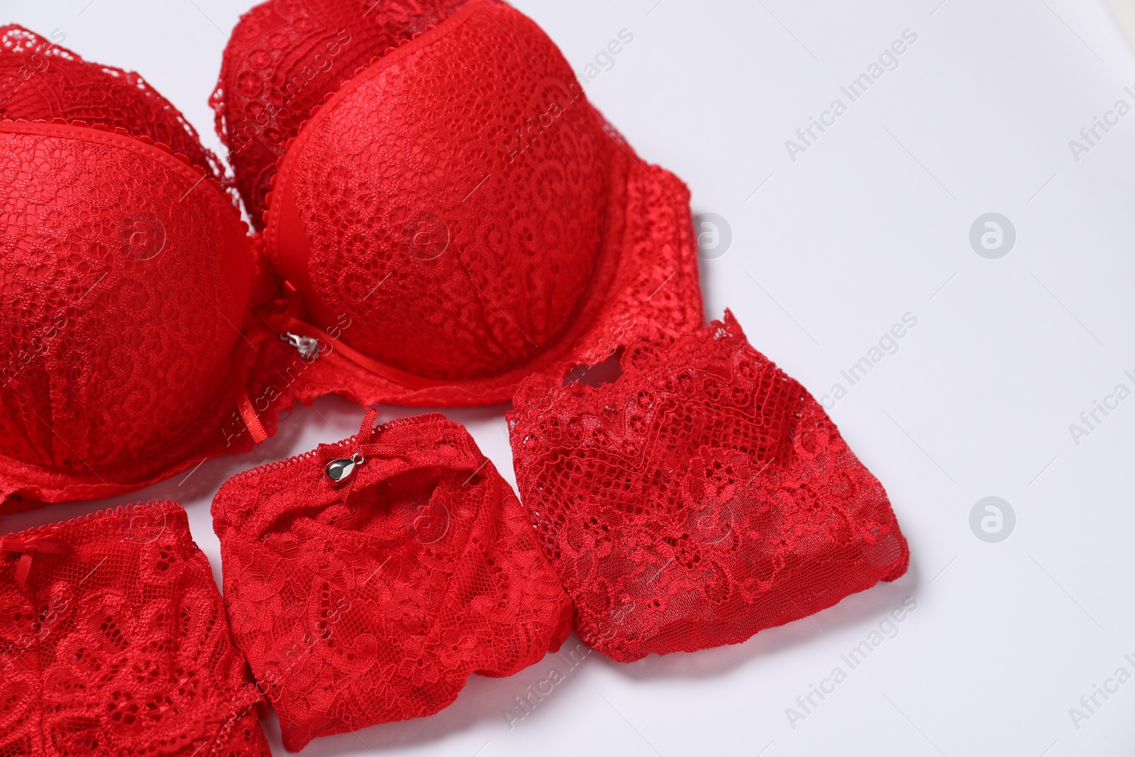 Photo of Stylish red women's underwear on white background, closeup